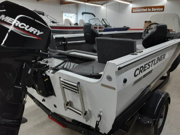 Slide: The Image of 2024 Crestliner 1650 Hawk fishing boat with Mercury outboard motor in showroom. - 6