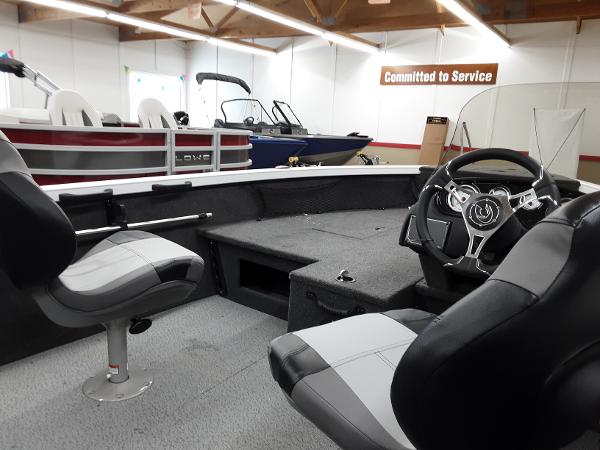 Slide: The Image of 2024 Crestliner 1650 Hawk boat interior with steering wheel and seating. - 7