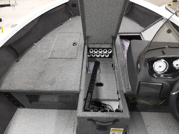 Slide: The Image of 2024 Crestliner 1650 Hawk boat interior with rod storage and dashboard. - 8