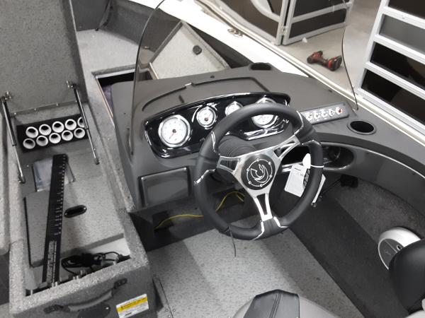Slide: The Image of 2024 Crestliner 1650 Hawk boat interior, featuring steering wheel and dashboard controls. - 9