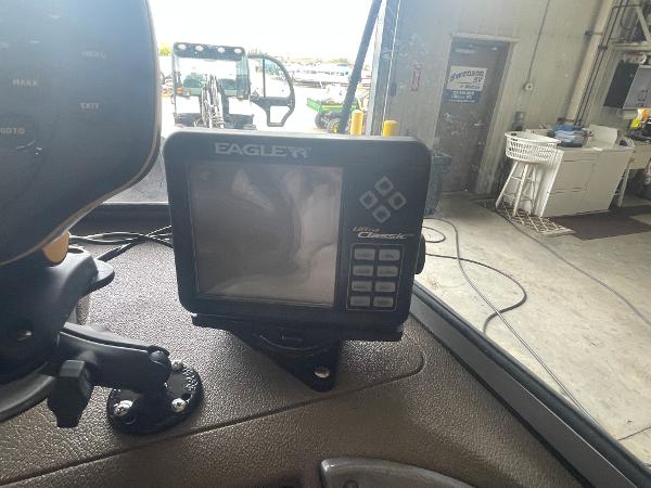 Slide: The Image of Eagle fish finder on a 2004 Crestliner 1700 SUPER HAWK boat dashboard in a garage. - 6