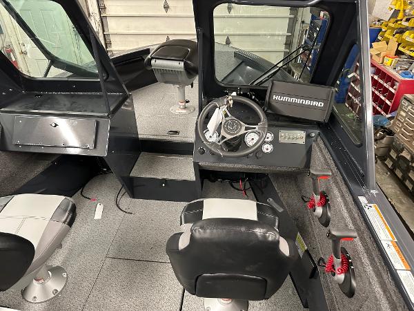 Slide: The Image of 2025 Crestliner 2050 Commander boat interior with steering console and seating. - 3
