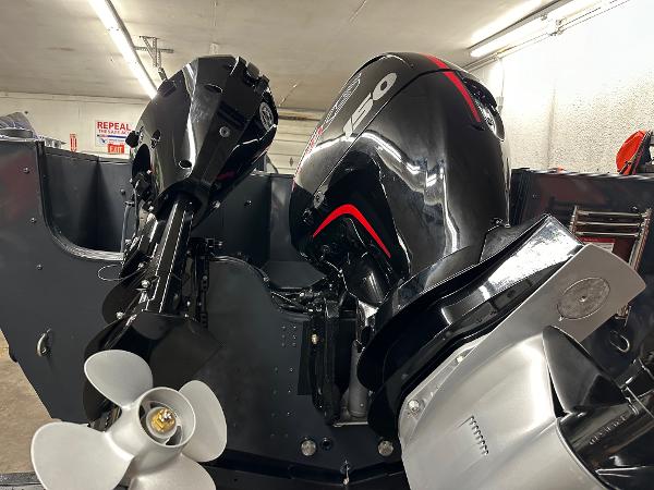 Slide: The Image of 2025 Crestliner 2050 Commander boat with powerful outboard motors in a garage. - 4