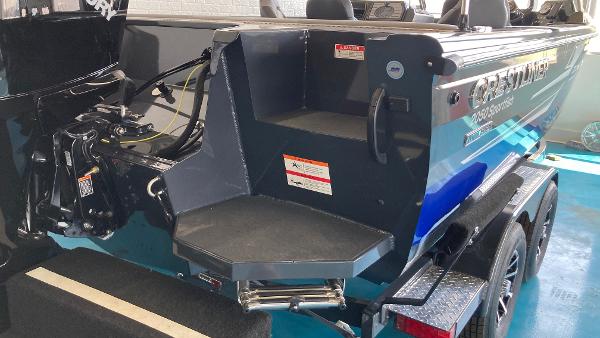 Slide: The Image of 2024 Crestliner 2050 Sportfish boat rear view with motor and trailer. - 2