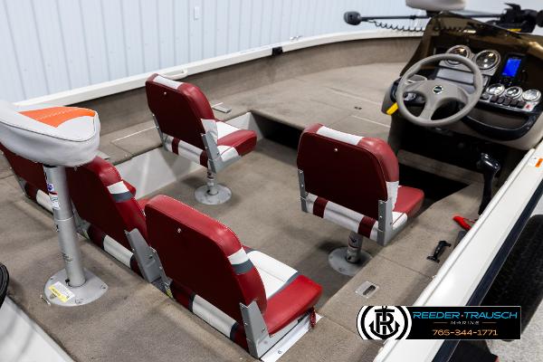 Slide: The Image of 2005 Crestliner 1750 FISHHAWK boat interior with red and white seats, steering wheel, and control panel. - 10