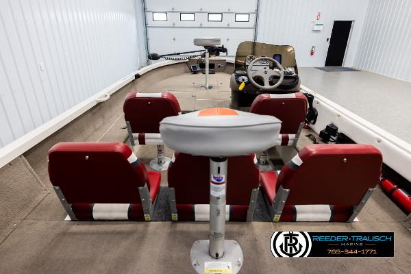 Slide: The Image of 2005 Crestliner 1750 FISHHAWK boat interior with red seats and steering console. - 11