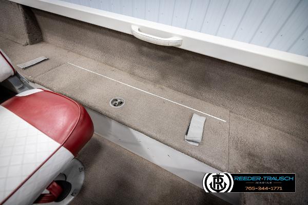 Slide: The Image of 2005 Crestliner 1750 FISHHAWK boat interior with red and white seating, storage compartment. - 20