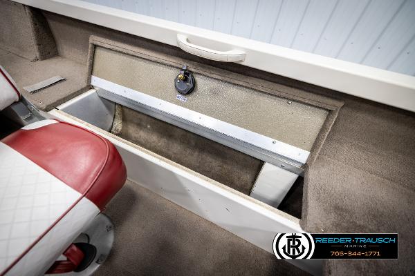Slide: The Image of 2005 Crestliner 1750 FISHHAWK boat interior with storage compartment and red seat. - 21