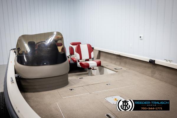 Slide: The Image of 2005 Crestliner 1750 FISHHAWK boat interior with red and white seating, windshield, and carpeted deck. - 25