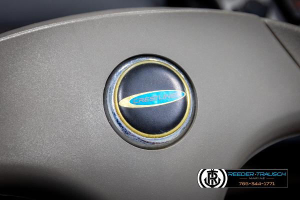 Slide: The Image of Crestliner 1750 FISHHAWK 2005 steering wheel emblem close-up. - 28