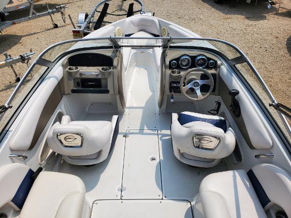 Slide: The Image of 2013 Crownline 19XS boat interior with steering wheel and seating. - 10