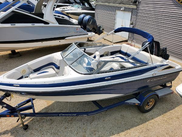 Slide: The Image of 2013 Crownline 19XS boat on a trailer, blue and white exterior. - 5