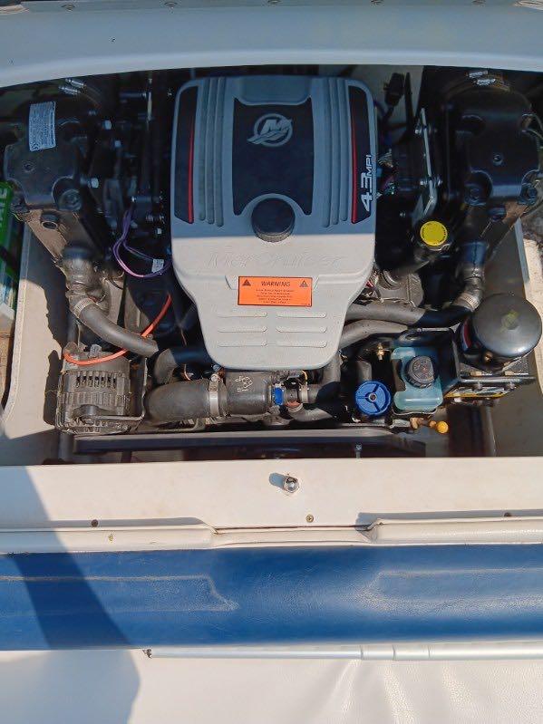 Slide: The Image of 2012 Crownline 21SS boat engine compartment with a 4.3L MerCruiser engine. - 10