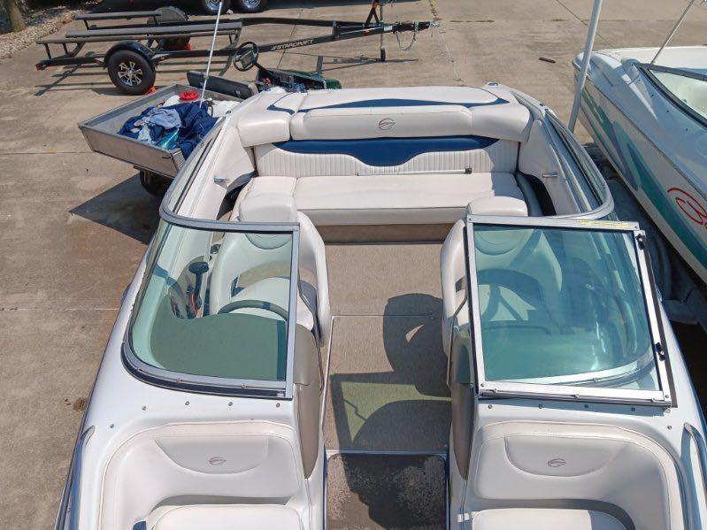 Slide: The Image of 2012 Crownline 21SS boat interior with white seating and open windshield. - 3