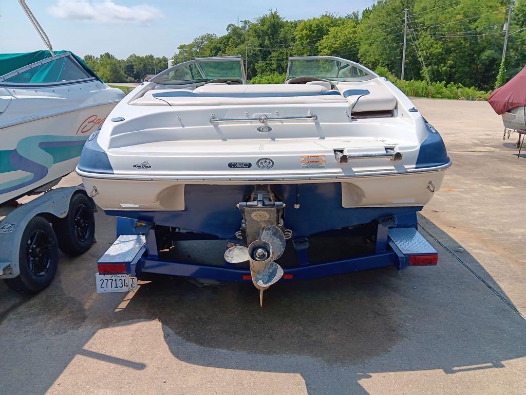 Slide: The Image of 2012 Crownline 21SS boat on trailer, rear view, parked outdoors. - 4