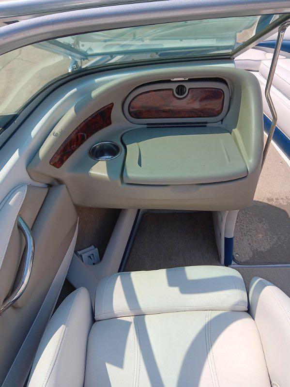 Slide: The Image of Interior of a 2012 Crownline 21SS boat with beige seating and dashboard. - 5