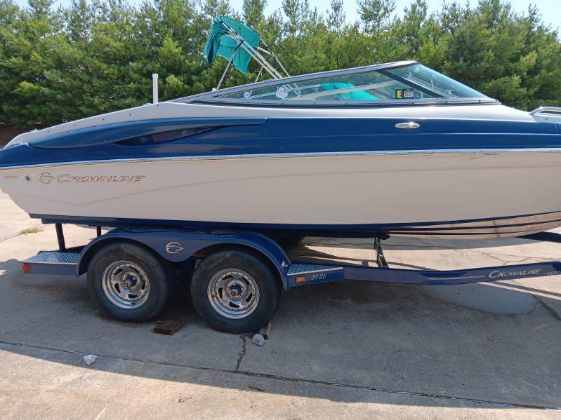 Slide: The Image of 2012 Crownline 21SS boat on a trailer, blue and white exterior. - 7