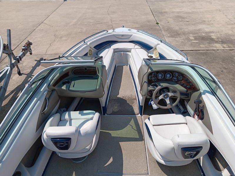 Slide: The Image of 2012 Crownline 21SS boat interior with white seating and dashboard. - 8