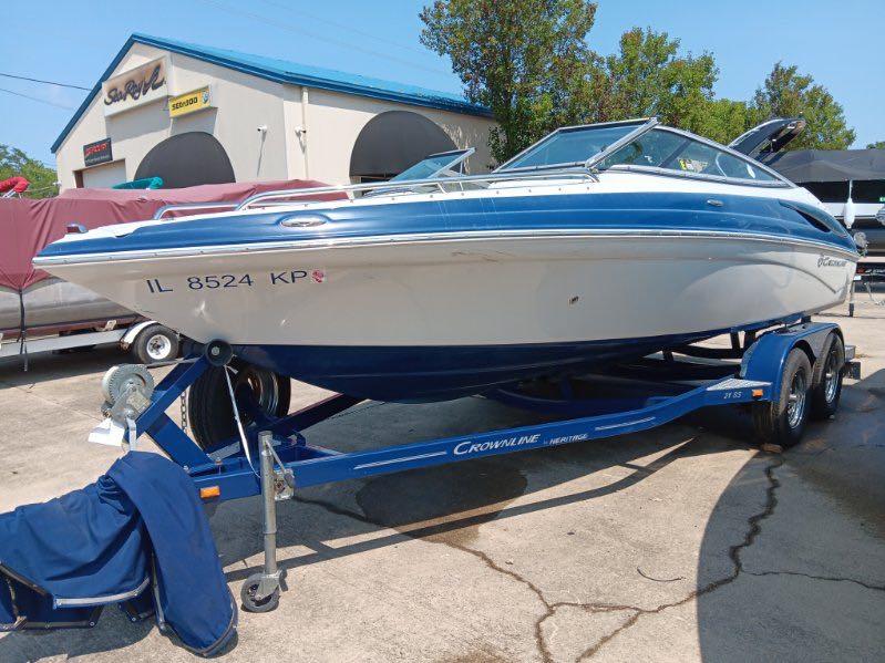 Slide: The Image of 2012 Crownline 21SS boat on a trailer in a marina parking lot. - 9