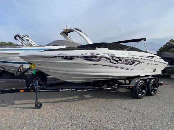 Slide: The Image of 2024 Crownline 220 SS LPX Bowrider boat on a trailer. - 1