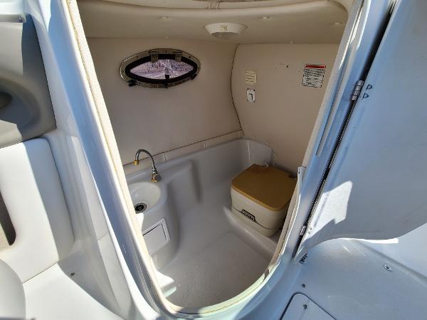 Slide: The Image of 2003 Crownline 230BR boat interior bathroom with sink and toilet. - 30
