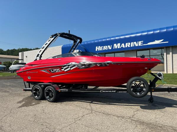 Slide: The Image of 2023 Crownline 240 SS boat in red on a trailer at Hern Marine dealership. - 0