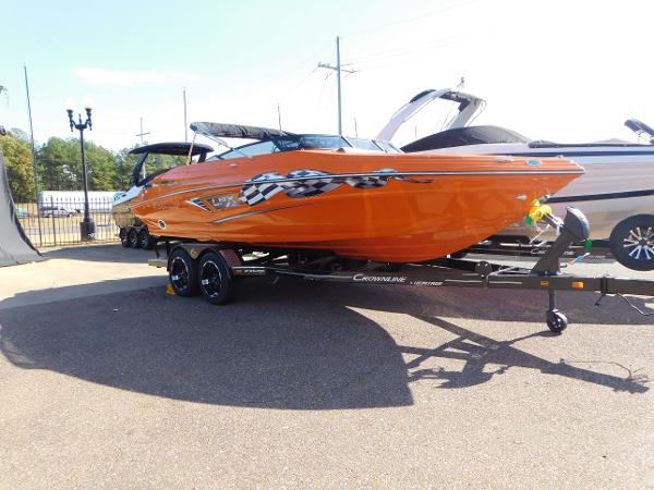 Slide: The Image of 2024 Crownline 240 SS LPX boat in vibrant orange on a trailer. - 0