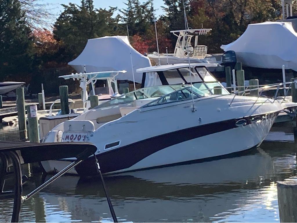 Slide: The Image of 2000 Crownline 268 boat docked at a marina. - 1
