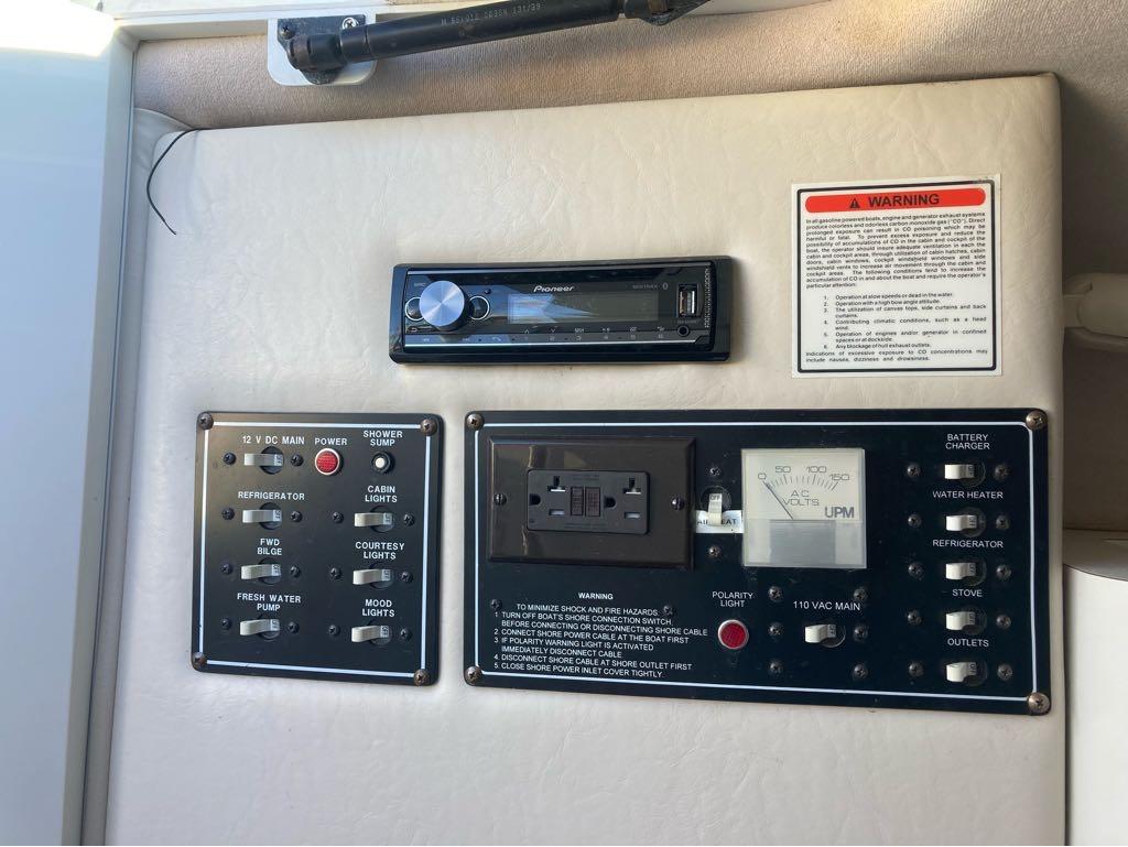 Slide: The Image of Control panel of a 2000 Crownline 268 boat with various switches and a Pioneer stereo. - 8