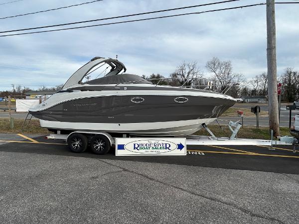Slide: The Image of 2024 Crownline 270 CR boat on a trailer at a dealership. - 2