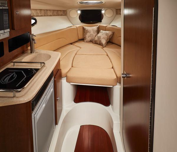 Slide: The Image of Interior cabin of 2024 Crownline 280 CRX boat with kitchenette and cozy sleeping area. - 12