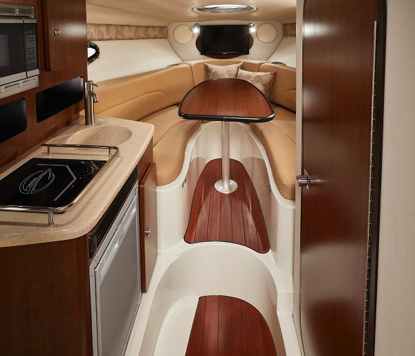 Slide: The Image of Interior of 2024 Crownline 280 CRX boat with kitchenette and seating area. - 13