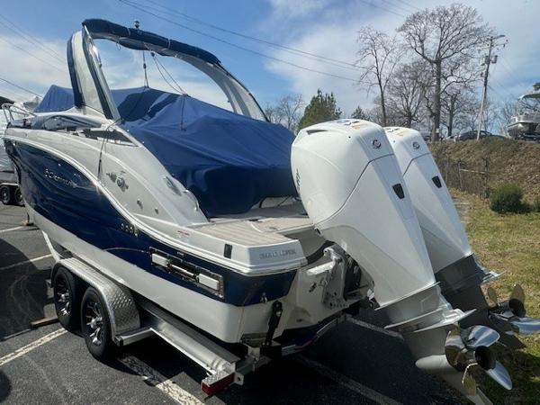 Slide: The Image of 2024 Crownline 280 CRX boat with twin outboard engines on a trailer. - 4