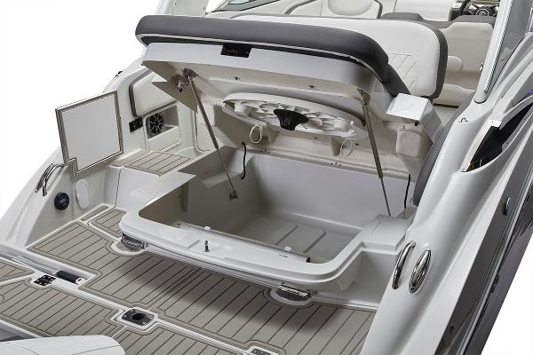 Slide: The Image of 2024 Crownline 280 CRX boat with open storage compartment and seating area. - 7