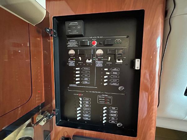 Slide: The Image of Electrical panel inside 2015 Crownline 350 SY boat, featuring various switches and controls. - 10