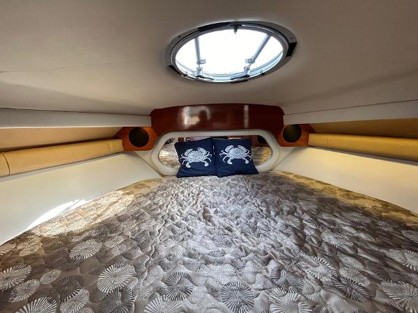 Slide: The Image of Interior cabin of 2015 Crownline 350 SY yacht with cozy bedding and porthole. - 11