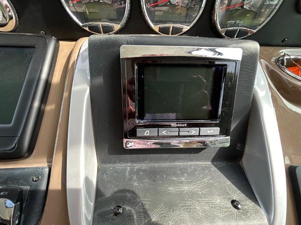 Slide: The Image of Dashboard of a 2015 Crownline 350 SY boat with electronic display and gauges. - 17