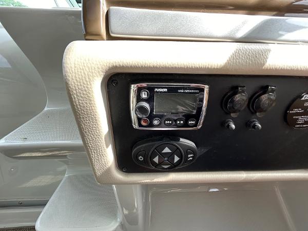 Slide: The Image of Control panel of 2015 Crownline 350 SY boat with audio system and switches. - 19