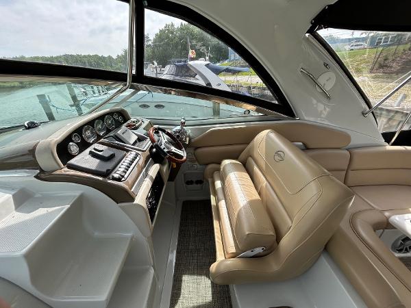 Slide: The Image of 2015 Crownline 350 SY yacht interior with beige seating and modern dashboard. - 20