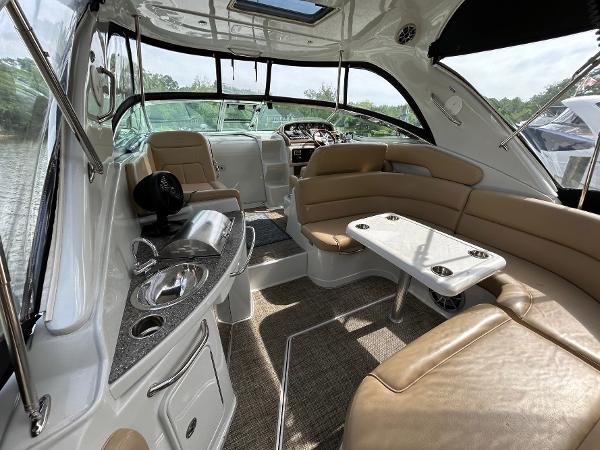 Slide: The Image of Interior of 2015 Crownline 350 SY yacht with seating, table, and helm. - 22