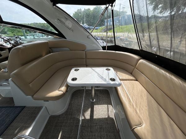 Slide: The Image of 2015 Crownline 350 SY yacht interior with tan seating and table. - 24
