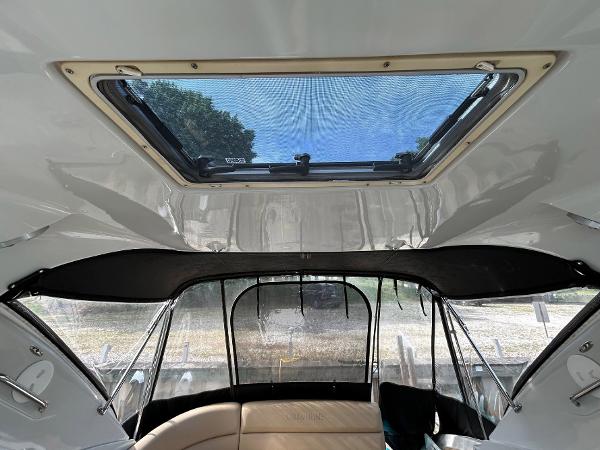 Slide: The Image of Interior view of 2015 Crownline 350 SY boat with sunroof and seating area. - 27