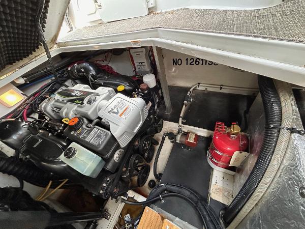 Slide: The Image of Engine compartment of a 2015 Crownline 350 SY boat, featuring a well-maintained engine and equipment. - 29