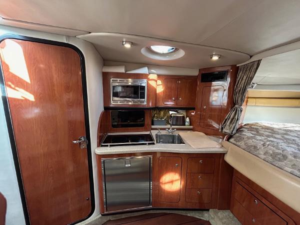 Slide: The Image of Interior of 2015 Crownline 350 SY yacht with modern kitchen amenities. - 7