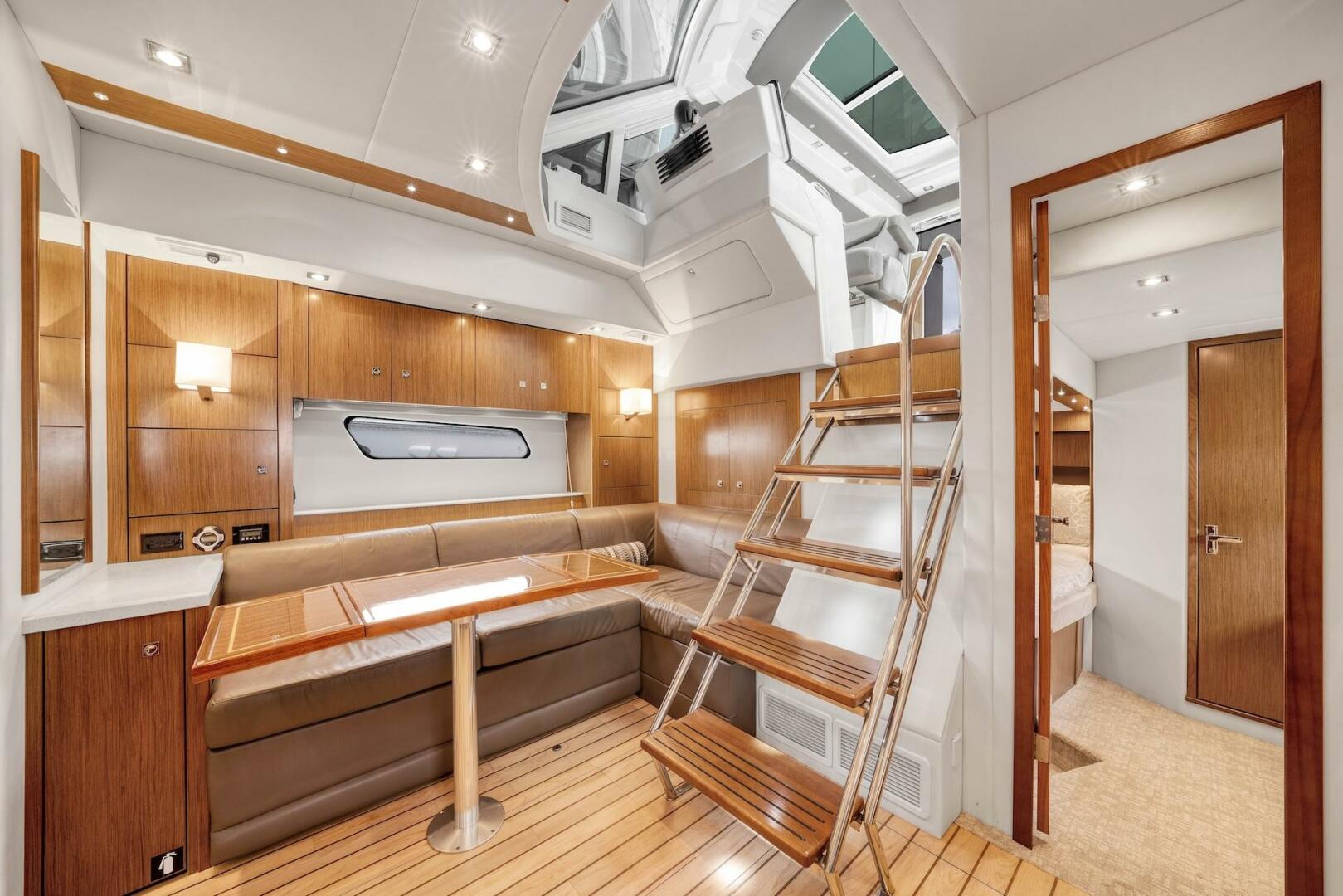 Slide: The Image of 2015 Cruisers Yachts 48 Cantius - Lower Dinette and Stairs to Helm - 5117020