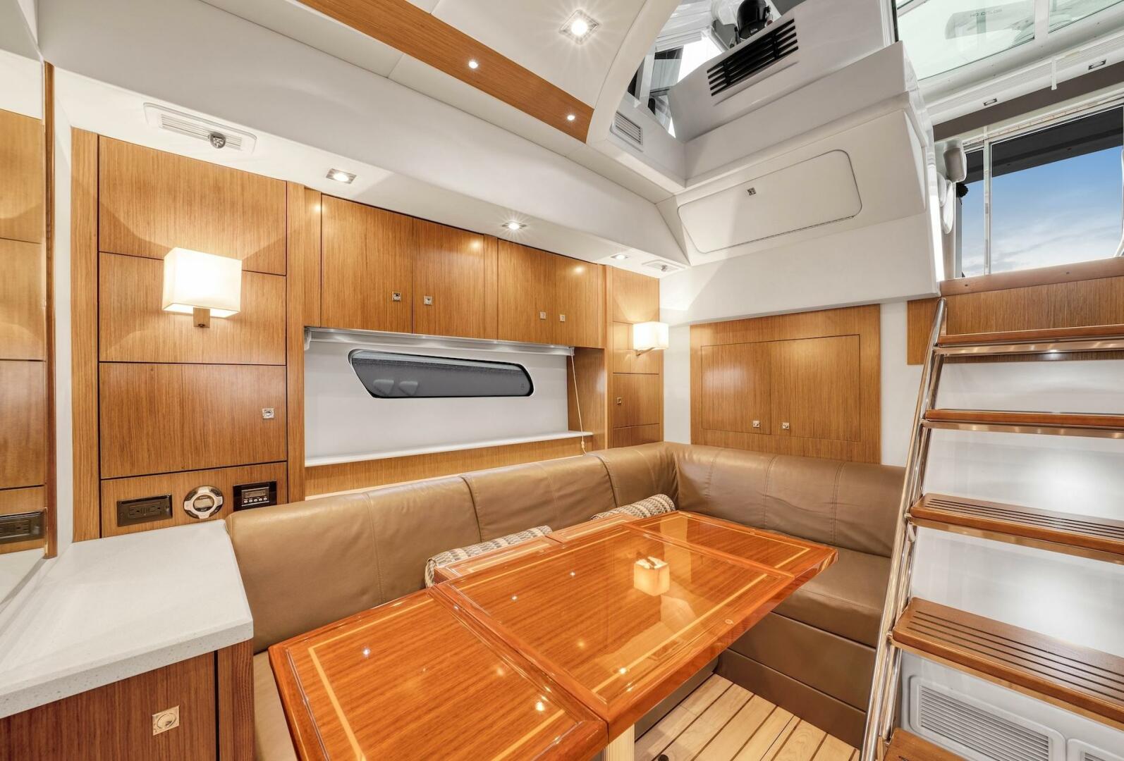 Slide: The Image of 2015 Cruisers Yachts 48 Cantius - Lower Dinette and stairs to helm - 5117008
