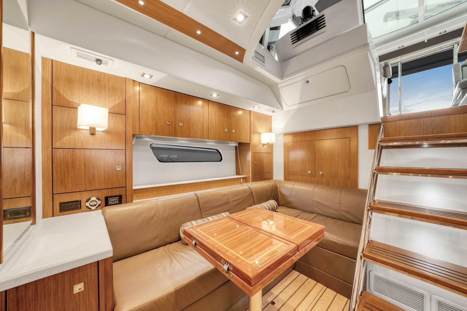 Slide: The Image of 2015 Cruisers Yachts 48 Cantius - Lower Dinette and Stairs to Helm - 5117009