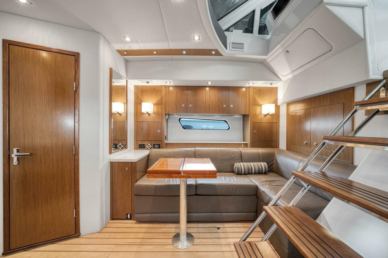 Slide: The Image of 2015 Cruisers Yachts 48 Cantius - Lower Dinette and stairs to helm - 5117026
