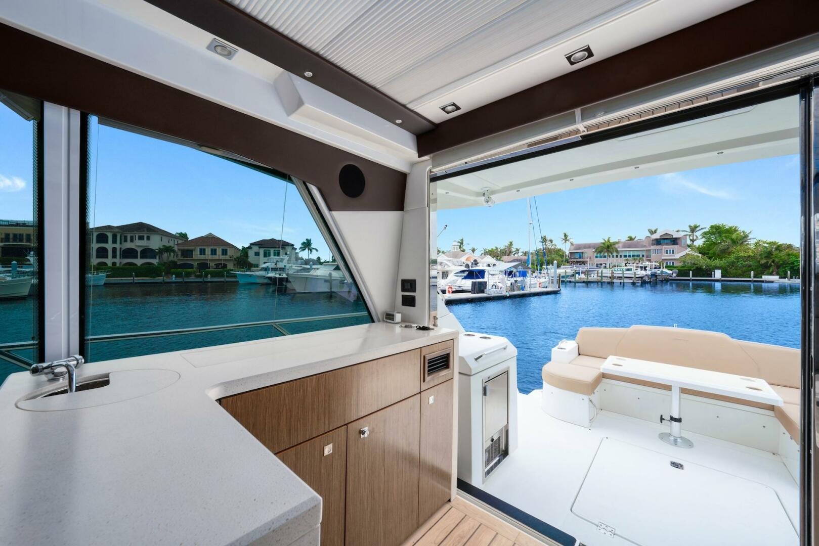 Slide: The Image of 2015 Cruisers Yachts 48 Cantius - Upper Salon & View of Cockpit - 5117042