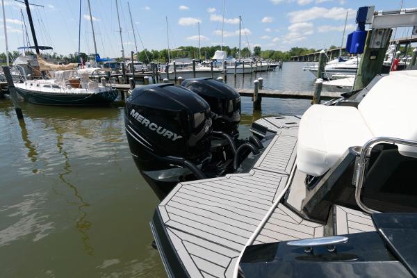 Slide: The Image of 2020 Cruisers Yachts 338 SS OB with Mercury outboards docked at a marina. - 18